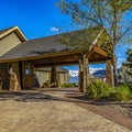 Square frame Exterior of a home with view of the paved driveway and pavilion at the entrance