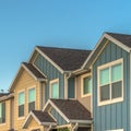 Square frame Exterior of upper storey of townhomes with blue sky background on a sunny day