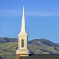 Square frame Focus on the roof and steeple of a church with classic red brick exterior wall Royalty Free Stock Photo