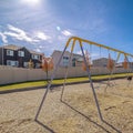 Square frame A-frame kids swings in a gravelled playground Royalty Free Stock Photo