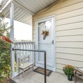 Square frame Front door exterior of a cottage style house with decorative flowers and plants Royalty Free Stock Photo