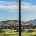 Square frame Golf course and houses on a residential area with fence in the foreground Royalty Free Stock Photo