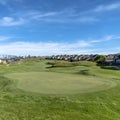 Square frame Golf course with view of lovely homes and mountain under blue sky with clouds Royalty Free Stock Photo