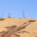 Square frame Group of communications towers on a hilltop Royalty Free Stock Photo