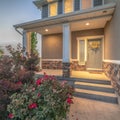 Square frame Home entrance with pathway and stairs leading to porch and door with wreath Royalty Free Stock Photo