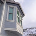 Square frame Home exterior in Park City Utah with bay window and gray horizontal wall siding Royalty Free Stock Photo