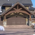 Square frame Home in Park City Utah in winter with gabled garage entrance against blue sky Royalty Free Stock Photo