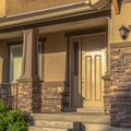 Square frame Home with stairs leading to the front door and porch against hill and sky view Royalty Free Stock Photo