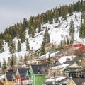 Square frame Houses with colorful walls built on a mountain covered with snow in winter