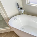 Square frame Interior of a bathroom with a smooth and glossy bathtub in th corner