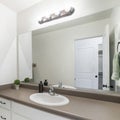 Square frame Interior of a bathroom with white marble top sink with white cabinet and mirror Royalty Free Stock Photo