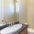 Square frame Interior of a cream colored bathroom with windows and sink Royalty Free Stock Photo
