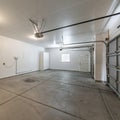 Square frame Interior of a garage with double automatic doors and concrete floor Royalty Free Stock Photo