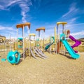 Square frame Kids playground with colorful blue slides during day