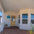 Square frame Long covered wooden entrance porch day light Royalty Free Stock Photo