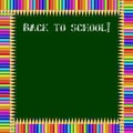 Square frame made of colorful pencils on green blackboard background with back to school chalky inscription and copy space. Royalty Free Stock Photo
