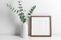 Square frame mockup over white wall with copy space for artwork, photo or print presentation