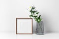 Square frame mockup in white minimalistic interior with fresh flowers in vase Royalty Free Stock Photo