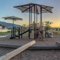 Square frame Neighborhood park with fun playground featuring slides and swings for children Royalty Free Stock Photo