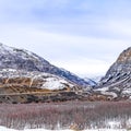 Square frame Panoramic view of an immense mountain dusted with snow against a cloudy sky