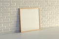 Square frame poster mock up on the white table with white brick wall on background Royalty Free Stock Photo