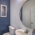 Square frame Powder room interior with blue wooden planks front wall and frames