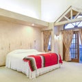 Square frame Spacious bedroom with beamed wooden ceiling