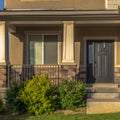 Square frame Stairs leading to porch and front door with sidelight at the entrance of home Royalty Free Stock Photo