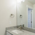 Square frame Vanity sink of a bathroom with granite countertop and wall mounted lights Royalty Free Stock Photo