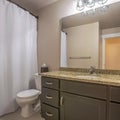 Square frame Vanity unit toilet and towel hook against the white wall of a well lit bathroom Royalty Free Stock Photo