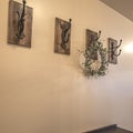 Square frame Wood cabinets and iron hooks against the beige wall of a home with white floor