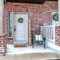 Square Front of apartment building with white front door and red brick exterior wall Royalty Free Stock Photo
