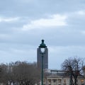 Square and funny view over a parisian street lamp with trees, Montparanasse tower and anciet buidlings Royalty Free Stock Photo