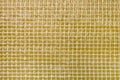Square geometrical mosaic yellow film texture background. Waterproofing layer of construction material. Wall damp course material