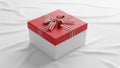 Square gift box with a white base and red lid, placed on a crinkled white fabric surface. The lid Royalty Free Stock Photo