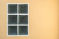 Square glass block windows on orange cement wall texture background Royalty Free Stock Photo