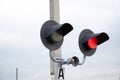 Square Grade crossing signal with red light gate and crossbuck at railroad crossing. Royalty Free Stock Photo