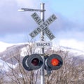 Square Grade crossing signal with red light gate and crossbuck at railroad crossing Royalty Free Stock Photo