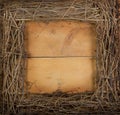 A square grapevine wreath on a wooden background Royalty Free Stock Photo