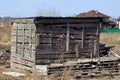 Square gray wooden shed from old boards outdoors