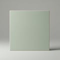 Square green ceramic tile displayed against a neutral gray background. The tile has a Royalty Free Stock Photo