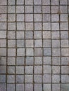 Square grey tiles on the floor or wall. Rusty gray background wi