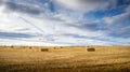 Square hay bales lying in a harvested field on the Canadian Prairies Royalty Free Stock Photo