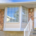 Square Home with a beautiful glass paned door and half hexagon shaped window