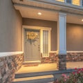 Square Home entrance with pathway and stairs leading to porch and door with wreath Royalty Free Stock Photo