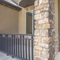 Square Home facade with brown wood door frosted sidelights and arched transom window