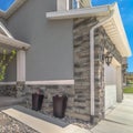 Square Home with gray and brick wall and landscaped yard leading to the entrance Royalty Free Stock Photo