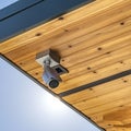 Square Home with security camera installed on the wooden underside of its roof