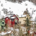 Square Homes built on the slope of a mountain blanketed with snow during winter