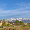 Square Houses on a hill overlooking a magnificent distant mountain capped with snow